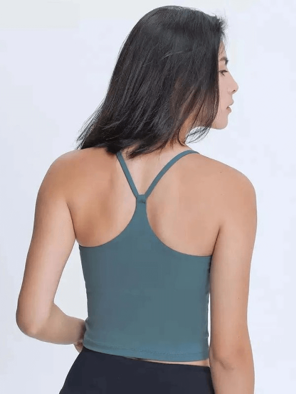 Back view of a sports elastic breathable women's tank top with straps, in blue, for fitness activities.